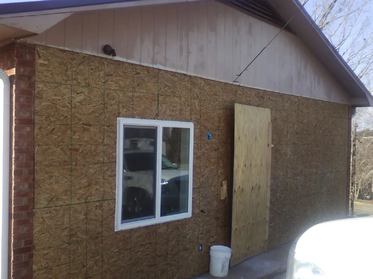 OSB sheathing on a garage addition wall before siding in Black River Falls